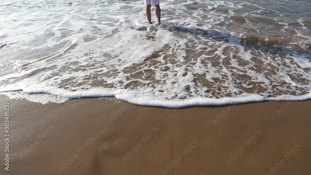 Woman enjoying walk on the sea waves in hot summer holiday vacation Woman enjoying walk on the sea waves in hot summer holiday vacation