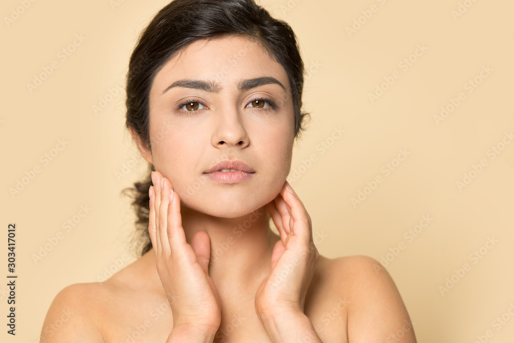 Head shot portrait Indian woman touching perfect smooth face skin Head shot portrait Indian woman touching perfect smooth face skin