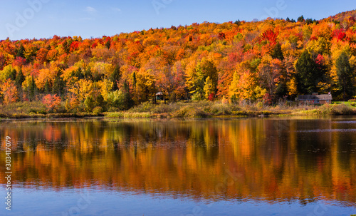 lake with wooded hills in autumn fall foliage