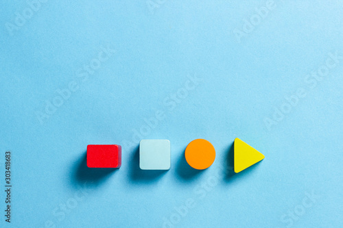 Fotografie Children's educational toys geometric shapes for logic on a blue background
