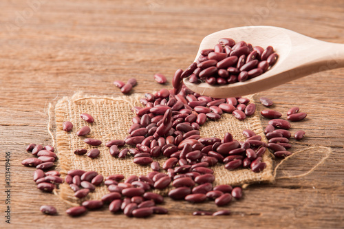 Red kidney bean close up rith spoon on wooden desk photo