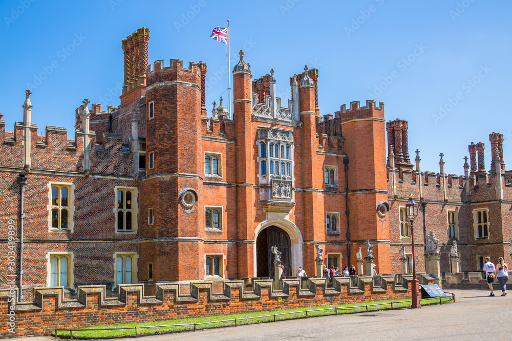 London, UK. English architecture Tudors time, West Front of Hampton court with entrance gate, locates in West London