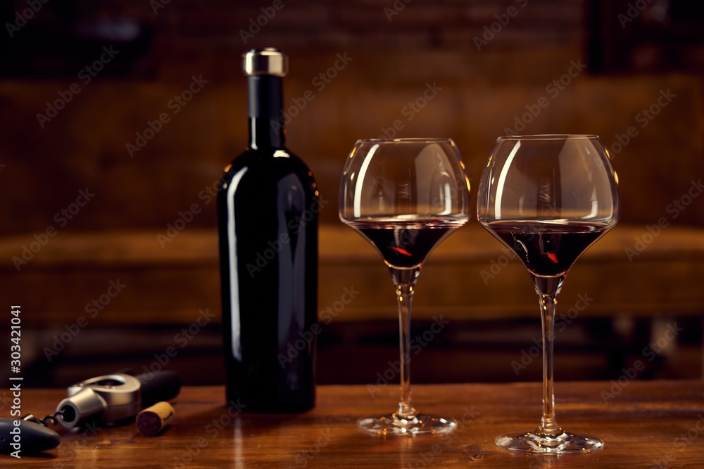 Glasses of red wine on table at home