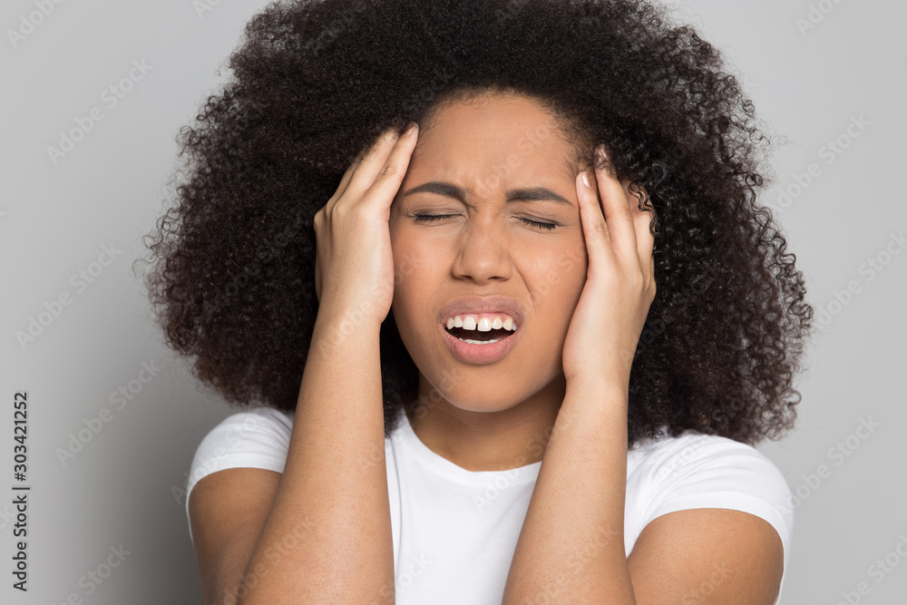 Φωτογραφία Head shot unhappy African American girl touching temples, feeling pain