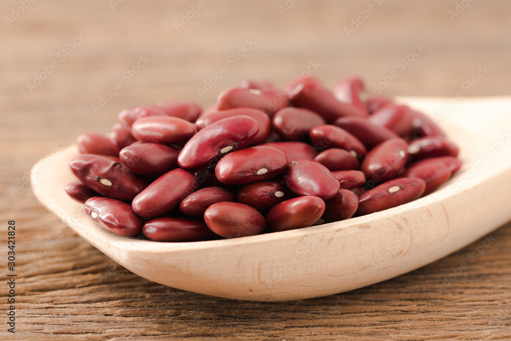 Red kidney bean close up rith spoon on wooden desk Red kidney bean close up rith spoon on wooden desk