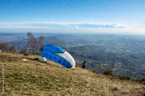 Paraglider takeoff on the mountains, italian Alps. Piedmont