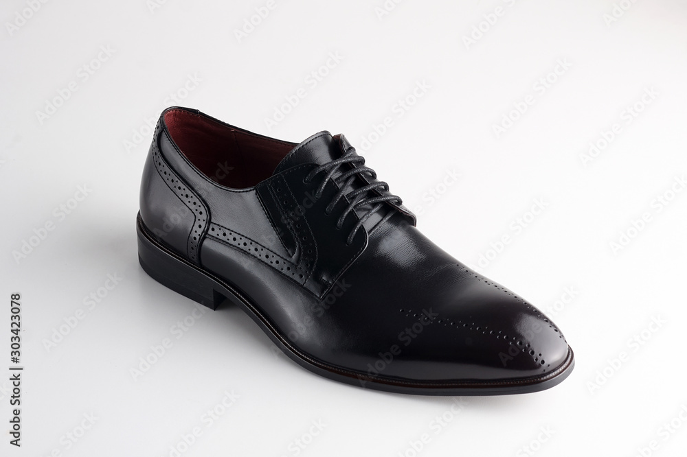 brown man's leather shoe with shoelaces on white background brown man's leather shoe with shoelaces on white background