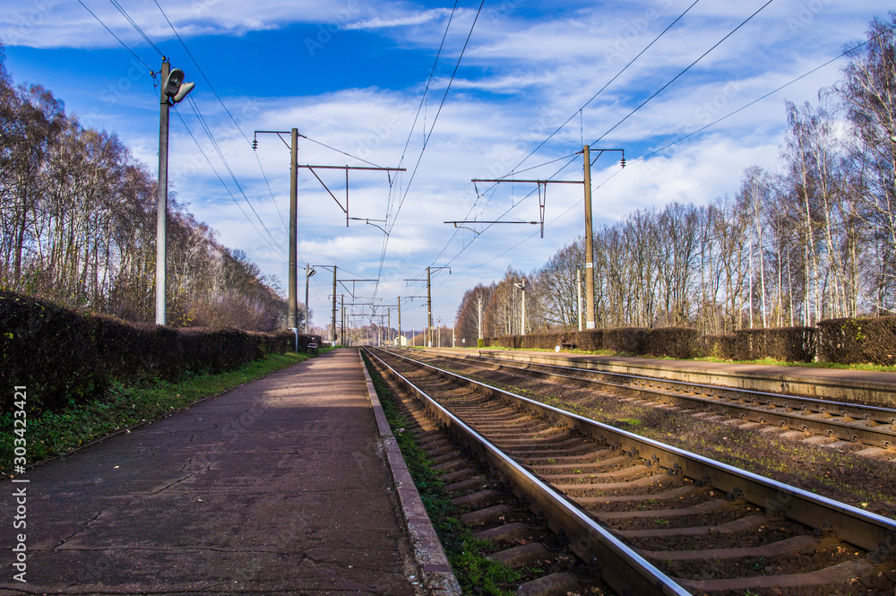 Railway iron rails at the station go to the horizon.