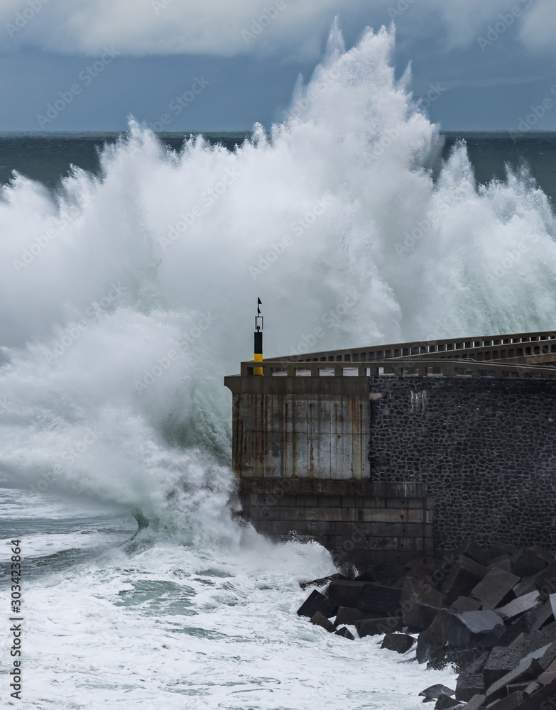Shocking wave hitting the breakwater of Mutriku, Spain, on the Basque coast