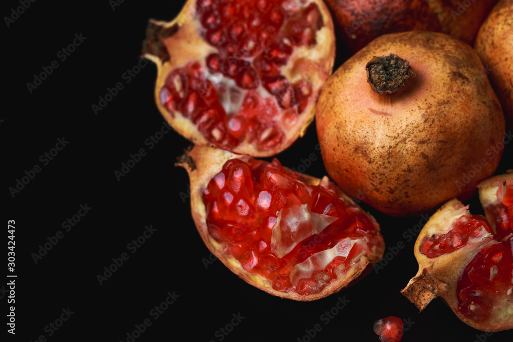 Still life of pomegranate on black background. Dark food concept Still life of pomegranate on black background. Dark food concept