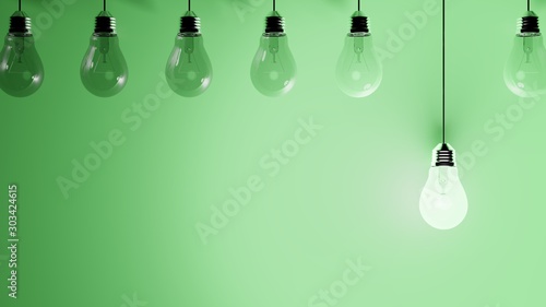 Hanging light bulbs on green background