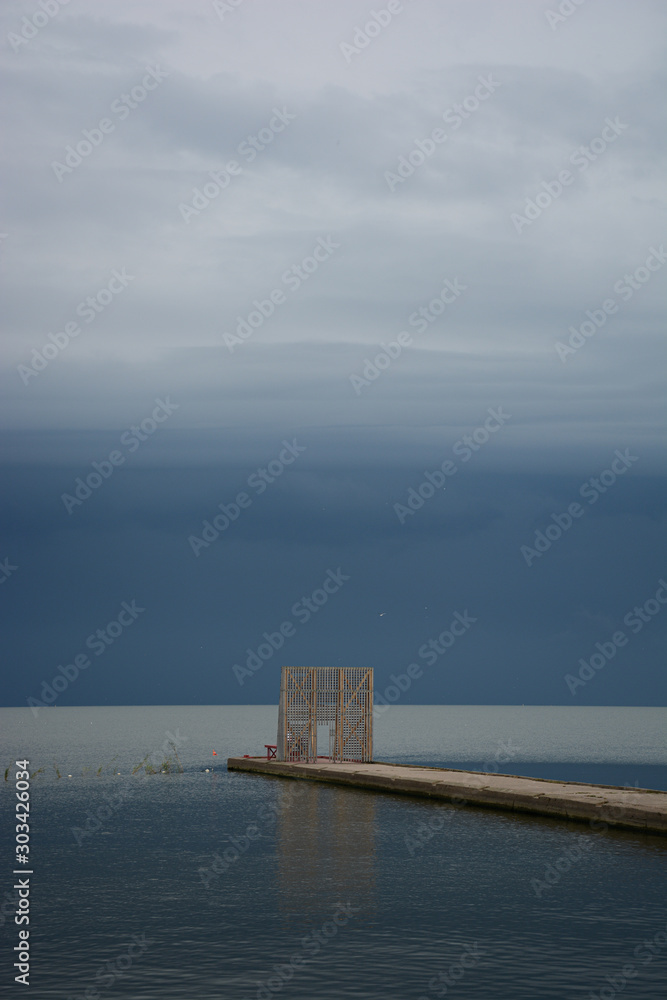 wooden pier on the sea in the storm