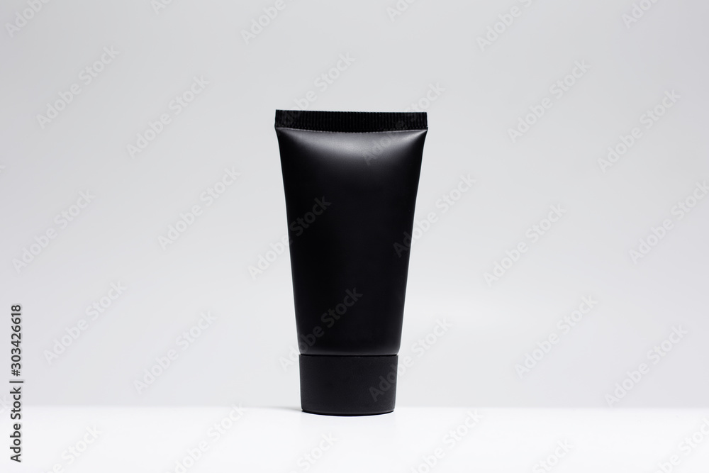 Close-up of black cream tubes with mockup isolated on white background. Close-up of black cream tubes with mockup isolated on white background.