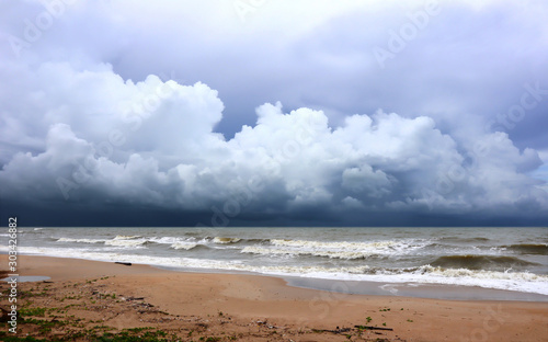 Lonely beach with view over the sea to dramatic looking storm clouds.
