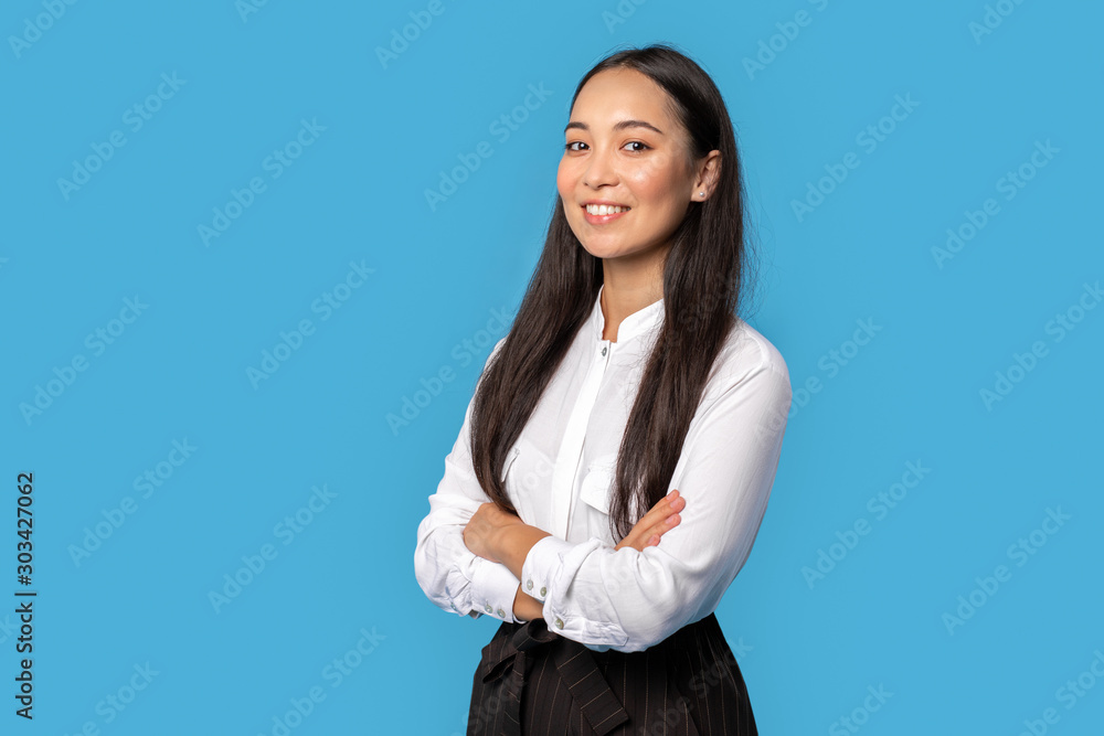 Freestyle. Young woman wearing shirt and skirt standing isolated on blue crossed arms posing confident Freestyle. Young woman wearing shirt and skirt standing isolated on blue crossed arms posing confident