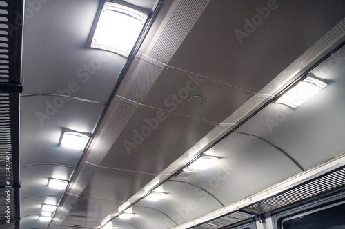 Interior of an empty train carriage ceiling view.