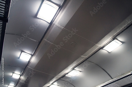 Interior of an empty train carriage ceiling view.
