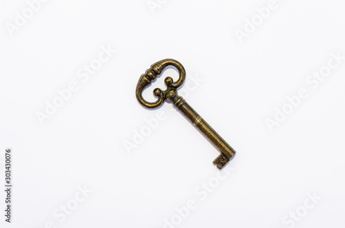 Vintage bronze key isolated on white background © mina709