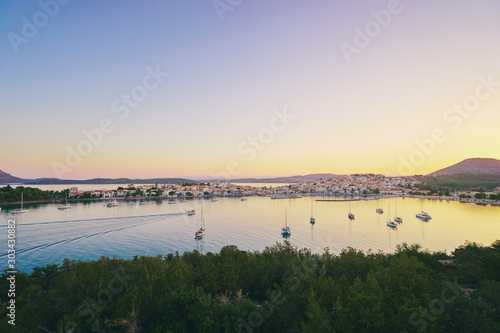 Travel by Greece. Beautiful view of Ermioni sea lagoon with moored yachts at sunset time.