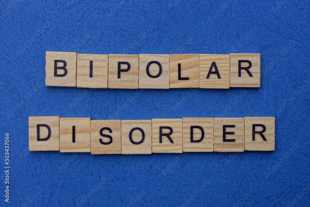bipolar disorder made from brown wooden letters lies on a blue table bipolar disorder made from brown wooden letters lies on a blue table