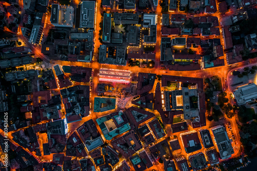 Overhead aerial drone night shot of city street lights in Lugano, Switzerland