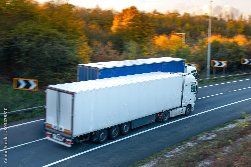 Two lorries on the road driving side by side Two lorries on the road driving side by side