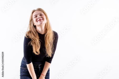 young beautiful blonde girl with a lovely shy smile on a white background