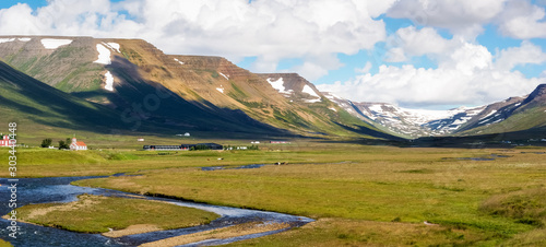 Panoramic of a valley with river and small buildings in Skagafjörður, in northern Iceland on a sunny day