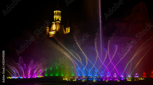 Fototapeta Naklejka Na Ścianę i Meble -  Colorful water fountains. Beautiful laser and fountain show. Large multi colored decorative dancing water jet led light fountain show at night. Dark background.