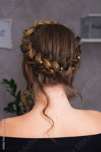 festive hairstyle elegant evening and bridal look, young adult beautiful woman with braid and pearls, close up, hairstyle and make up, saloon poster ready, girl with blue eyes, portrait model smiling