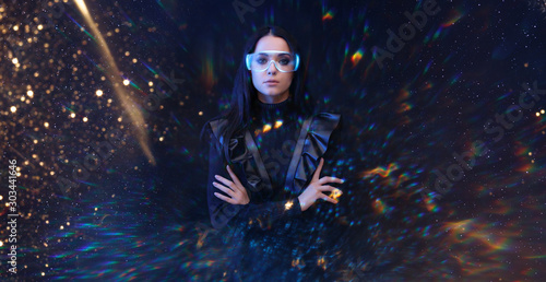 Beautiful young woman on virtual reality background. Augmented reality, future technology concept. VR. Futuristic 3d glasses with virtual projection. Blue, golden, rainbow light flares.