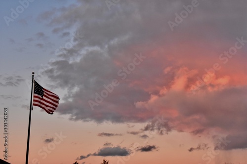 american flag in front of blue sky