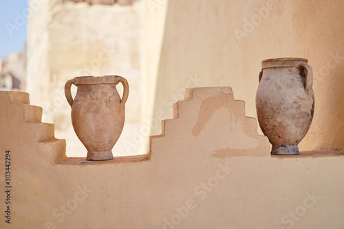 Ancient amphora jugs as decoration of the wall. photo