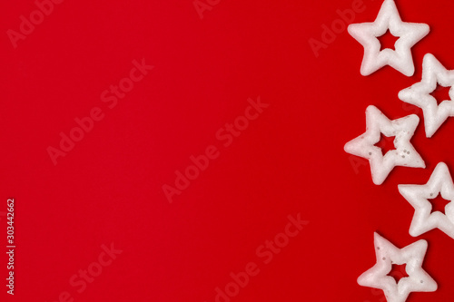 Christmas composition: flat lay white stars on a red background. Place for text