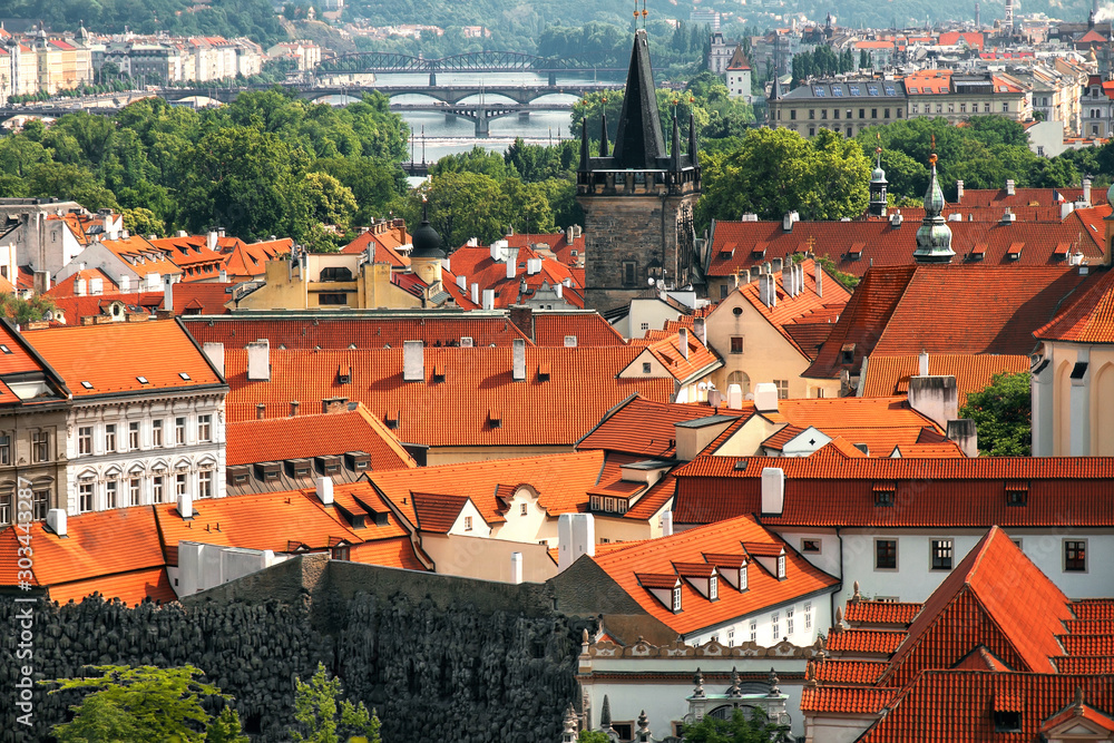 Φωτογραφία cityscape of Prague, red and yellow tiled roofs of city from above on sunny day