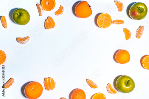 Composition with shelled Mandarin, green apples on white. Fresh peeled mandarin orange on white background. Mandarines, tangerine, clementine