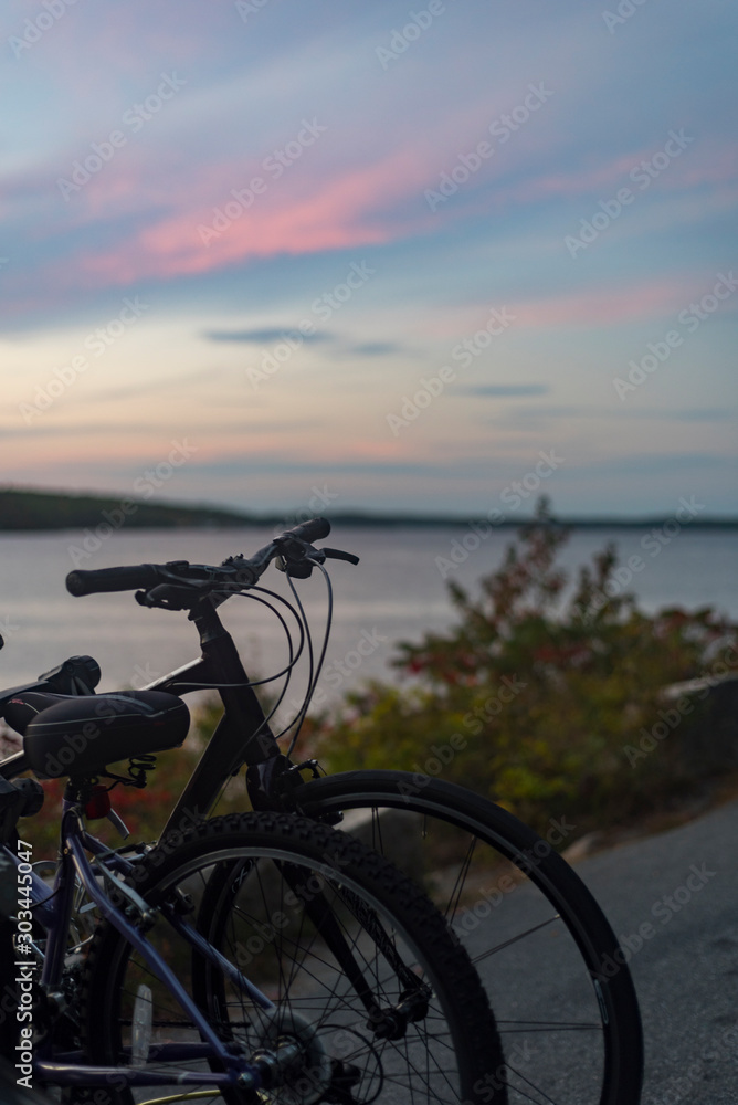 Bikes by a lake at sunset