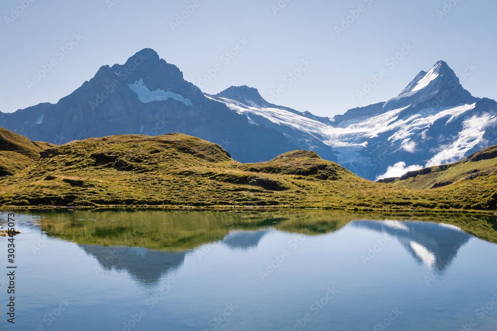 Lake Bachalpsee with snow covered mountain peaks in Bernese Alps, Switzerland