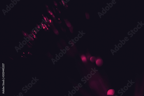 Lens Flare. Light bokeh, black background. Easy to add over photos. Abstract sun burst with digital lens flare background. Gleams rounded and hexagonal shapes. Bokeh light, shimmering blur spot lights