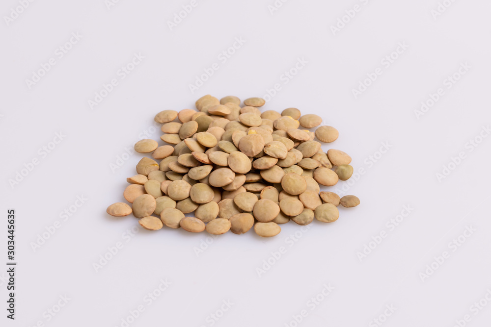 Dry uncooked lentils isolated on white background, copy space, studio shot, soft light. Christmas and New Year dish Dry uncooked lentils isolated on white background, copy space, studio shot, soft light. Christmas and New Year dish