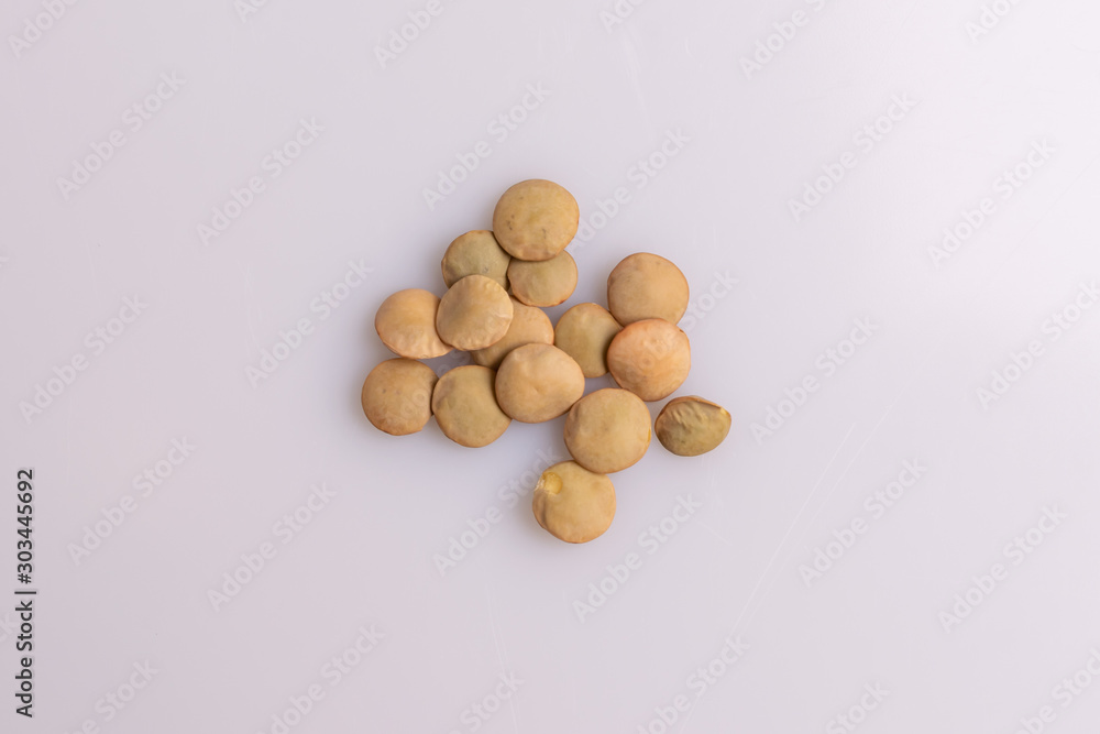Dry uncooked lentils isolated on white background, copy space, studio shot, soft light. Christmas and New Year dish Dry uncooked lentils isolated on white background, copy space, studio shot, soft light. Christmas and New Year dish