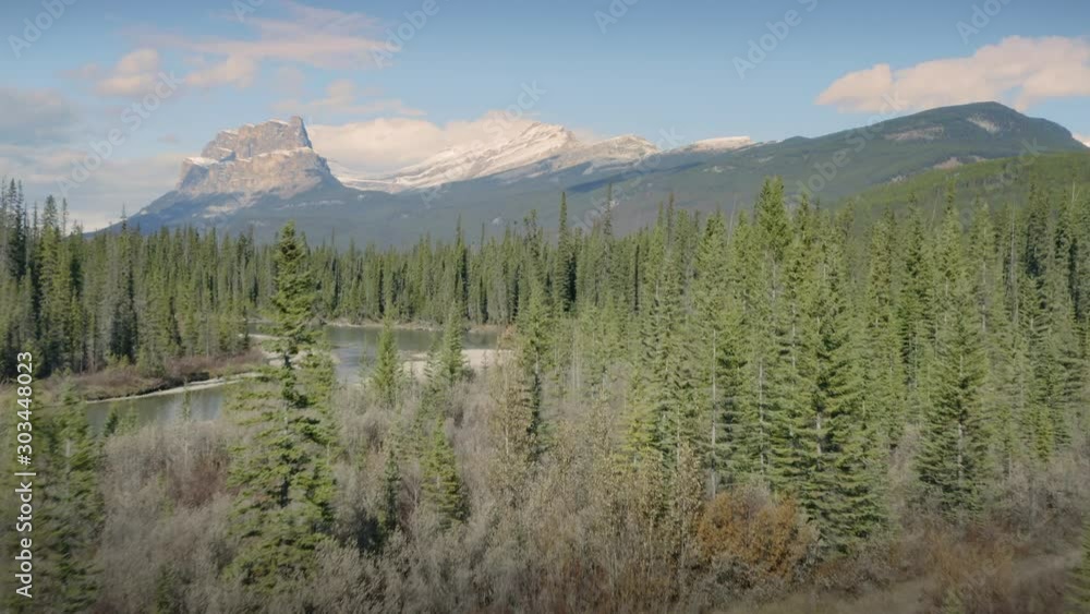 Aerial: Flying over the Bow River and Forest in the Canadian Rocky Mountains. Banff, Alberta, Canada. Aerial: Flying over the Bow River and Forest in the Canadian Rocky Mountains. Banff, Alberta, Canada.