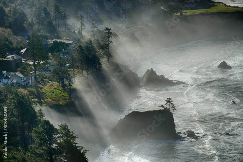 Misty morning headlands with slanting shafts of light photo