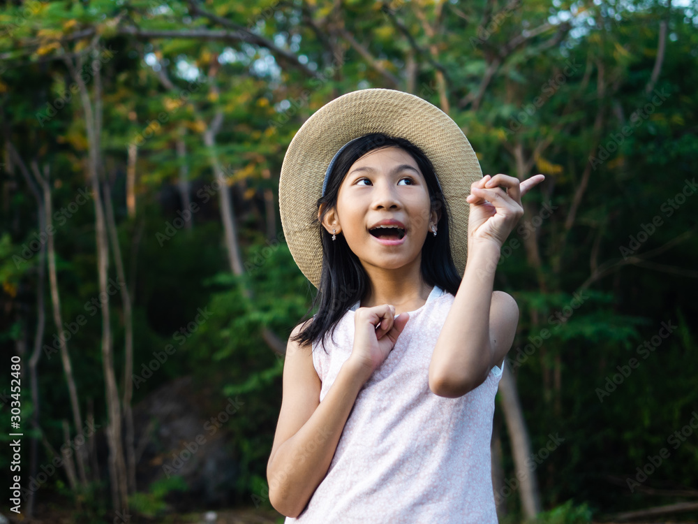 Asian girl wearing hat with nature background outdoor, lifestyle concept.