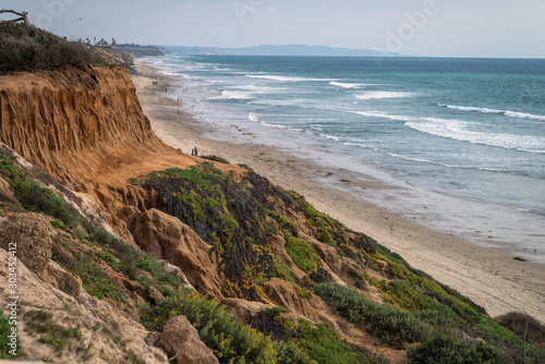 A view of the California coastline from the bluffs in Carlsbad, California.  Deep paths of erosion can clearly be seen in the bluffs. photo