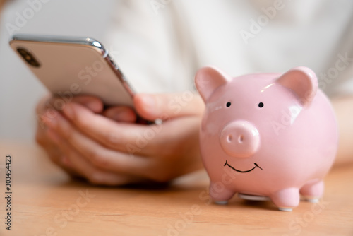 豚の貯金箱とスマートフォン photo