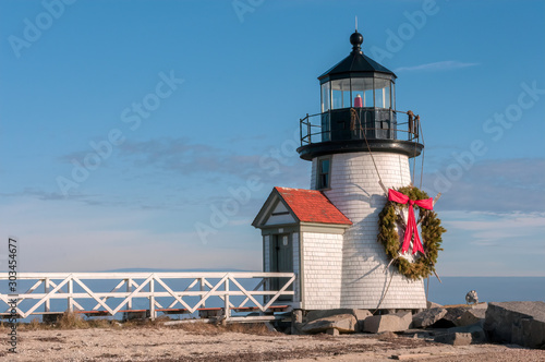 Brand Point Lighthouse, located on Nantucket Island in Massachusetts, decorated for the holidays with a Christmas wreath and crossed oars.