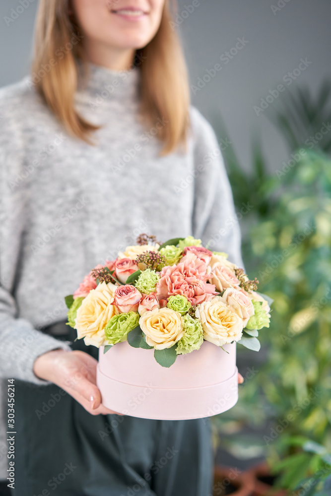 European floral shop. Floral bunch in round box. Bouquet of beautiful Mixed flowers in woman hand. Excellent garden flowers in the arrangement , the work of a professional florist. European floral shop. Floral bunch in round box. Bouquet of beautiful Mixed flowers in woman hand. Excellent garden flowers in the arrangement , the work of a professional florist.