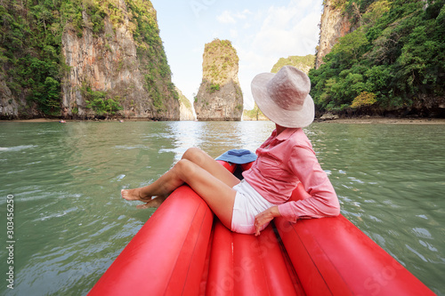 Traveling by Thailand. Tourist in hat enjoying sea view canoeing at Koh Hong Island. Phang-Nga. © luengo_ua
