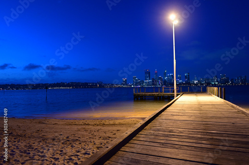 Perth central business district skyline as view from the Swan river bank pier at dusk